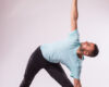 Concept of yoga. Handsome man doing yoga exercise isolated on a white background