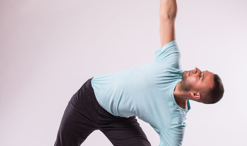 Concept of yoga. Handsome man doing yoga exercise isolated on a white background